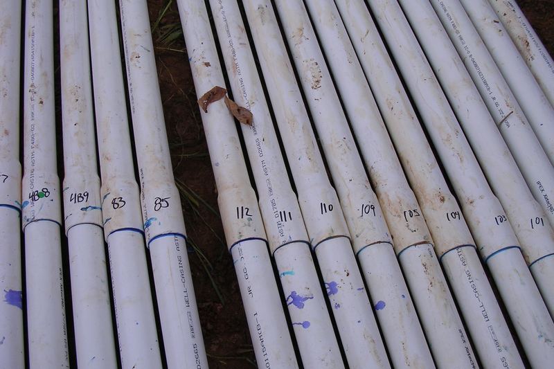 Lengths of PVC pipe laid out side by side before installation